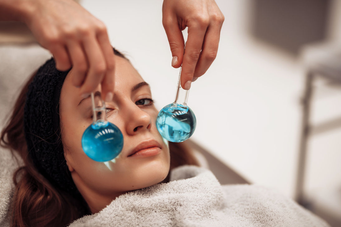 Person receiving a facial with ice globes